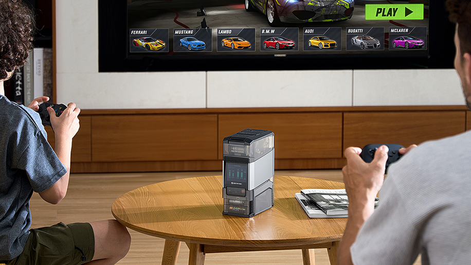 Two people playing a racing game with a high-capacity portable power station