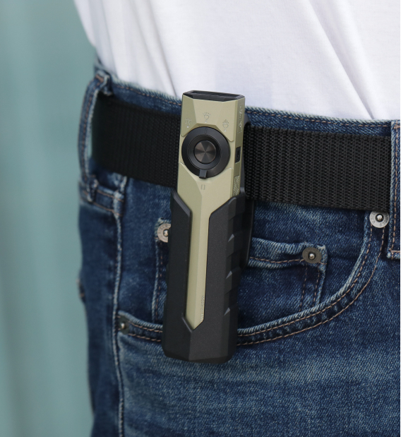 Compact olive green EDC flashlight with a rotary switch clipped to a belt on blue jeans, showcasing its portable design for everyday carry.